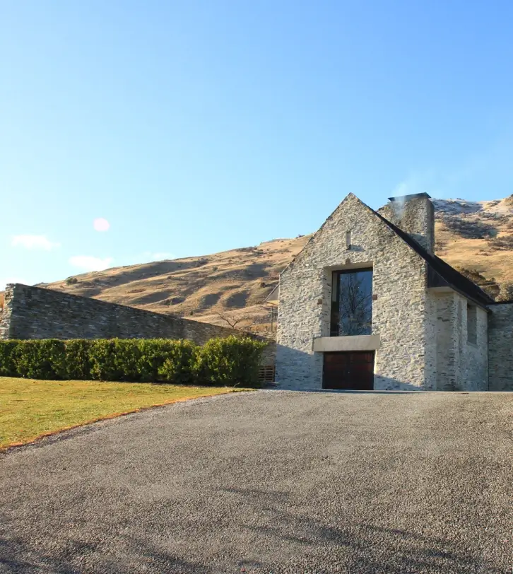 A prominent stone winery building in Central Otago, showcasing the region's architectural charm amidst scenic landscapes.
